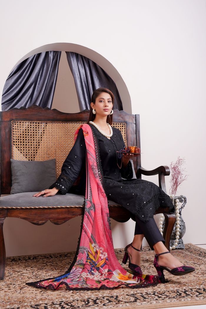 Stunning portrait of a woman in traditional Pakistani attire with vibrant dupatta.
