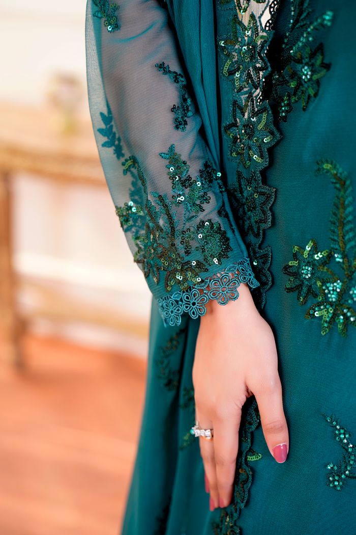 services-02 Close-up of a hand wearing an embroidered green chiffon dress, Lahore.